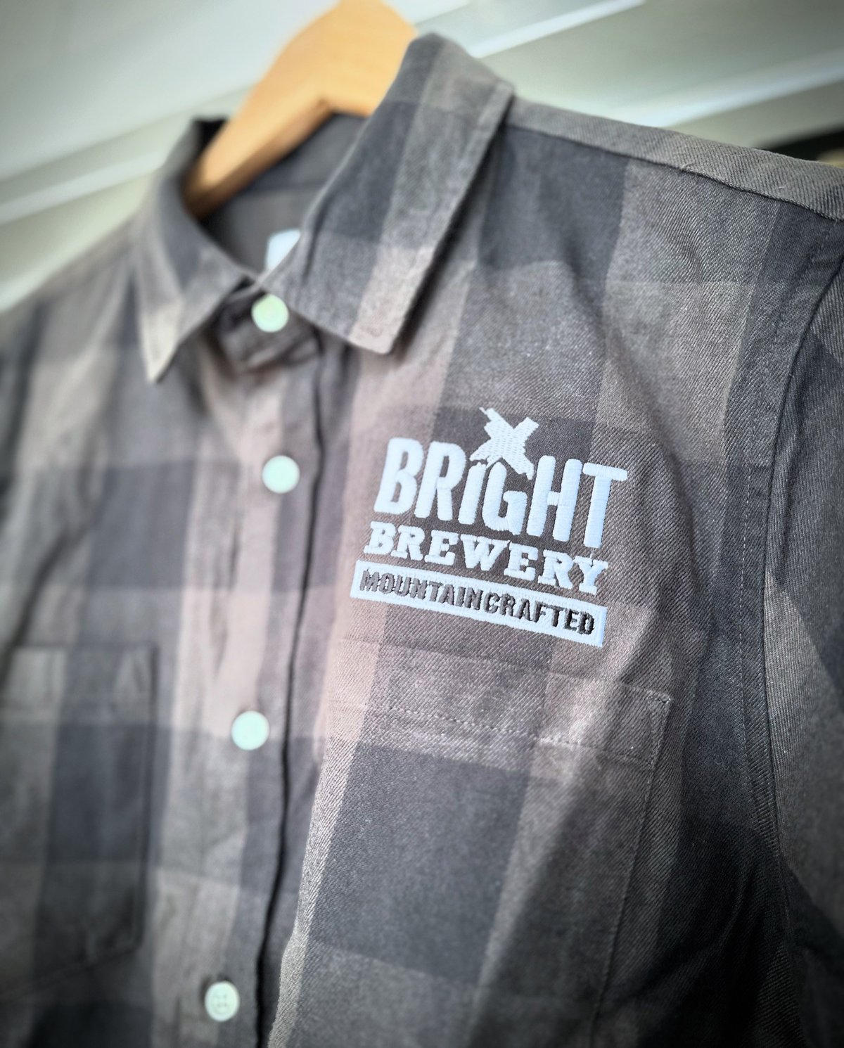 Bright Brewery embroidery by Melbourne Merch - crisp embroidery, moody lighting, professional composition with hanger context