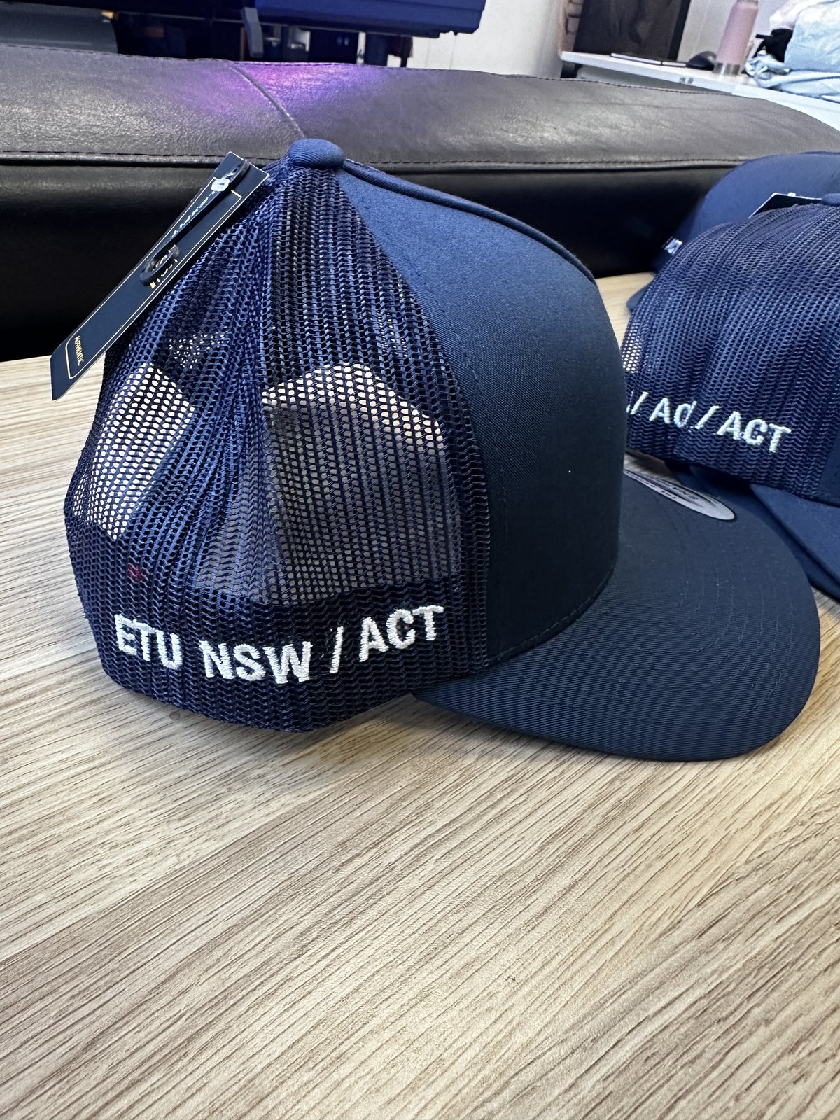 ETU Hats embroidered caps by Melbourne Merch - crisp embroidery and clean stack, nice lighting, brand reads cleanly