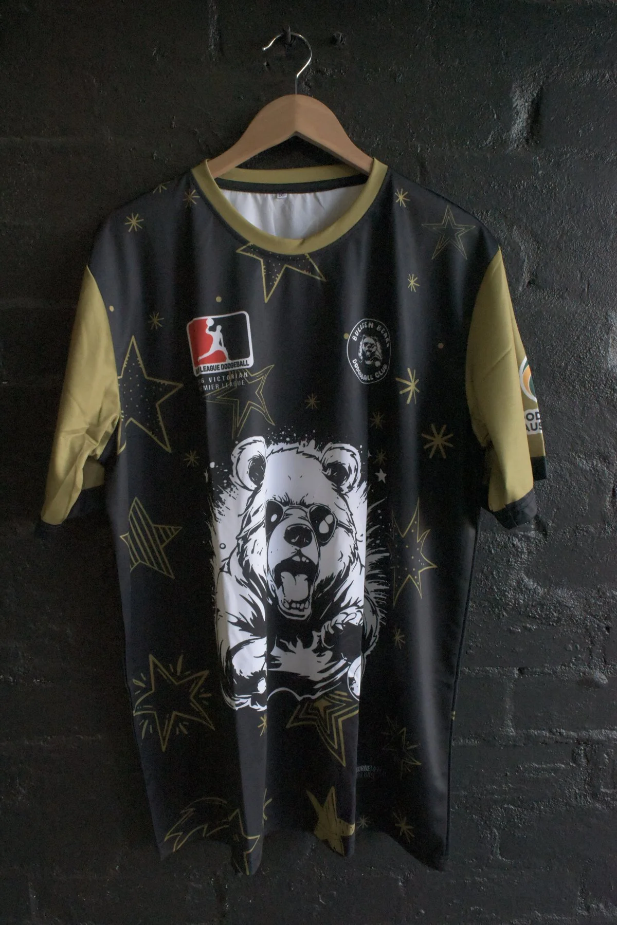Big League Dodgeball gold and black sublimated jersey with bear graphic