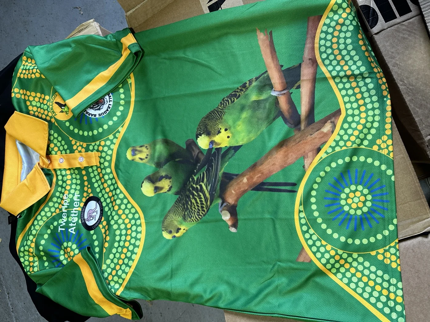 Twelve Atoner sublimated polo with photo-realistic Indigenous artwork edge-to-edge